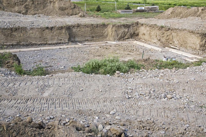 construction-basement-forms-excavation-new-building-hole-has-foundation-footings-background-dirt-piles-64646503